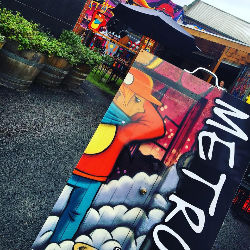 Metro's colourful mural-covered back courtyard, with wine barrels and herb planters
