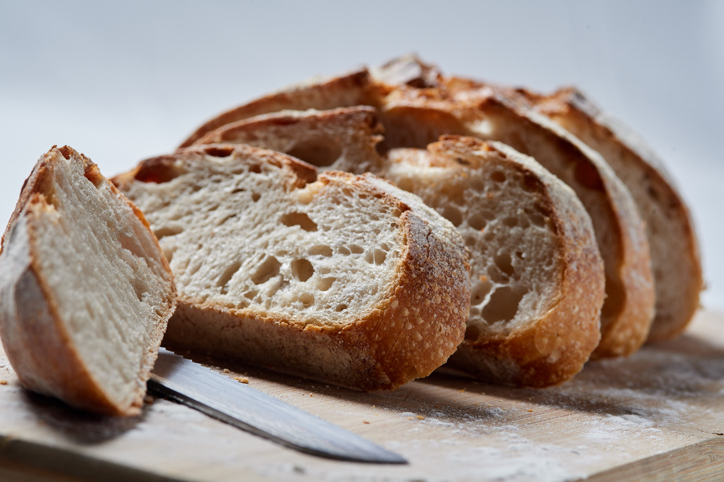 Metro's own sourdough loaf, sliced thick on a wooden board