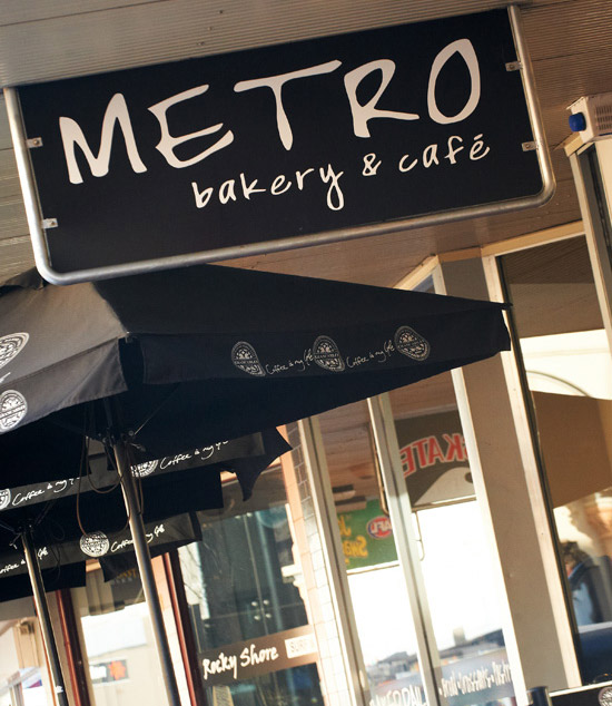 The Metro bakery and café sign above the footpath umbrellas on Commercial Street East