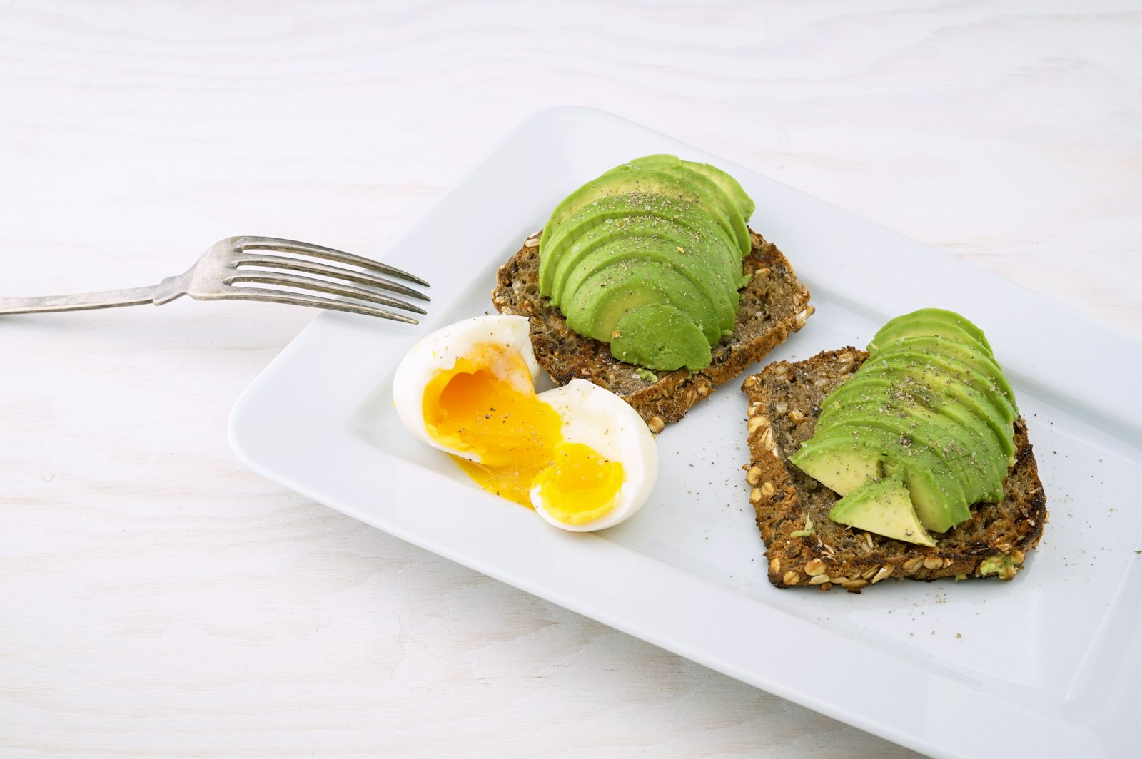 Avocado smash on seeded toast with a soft egg