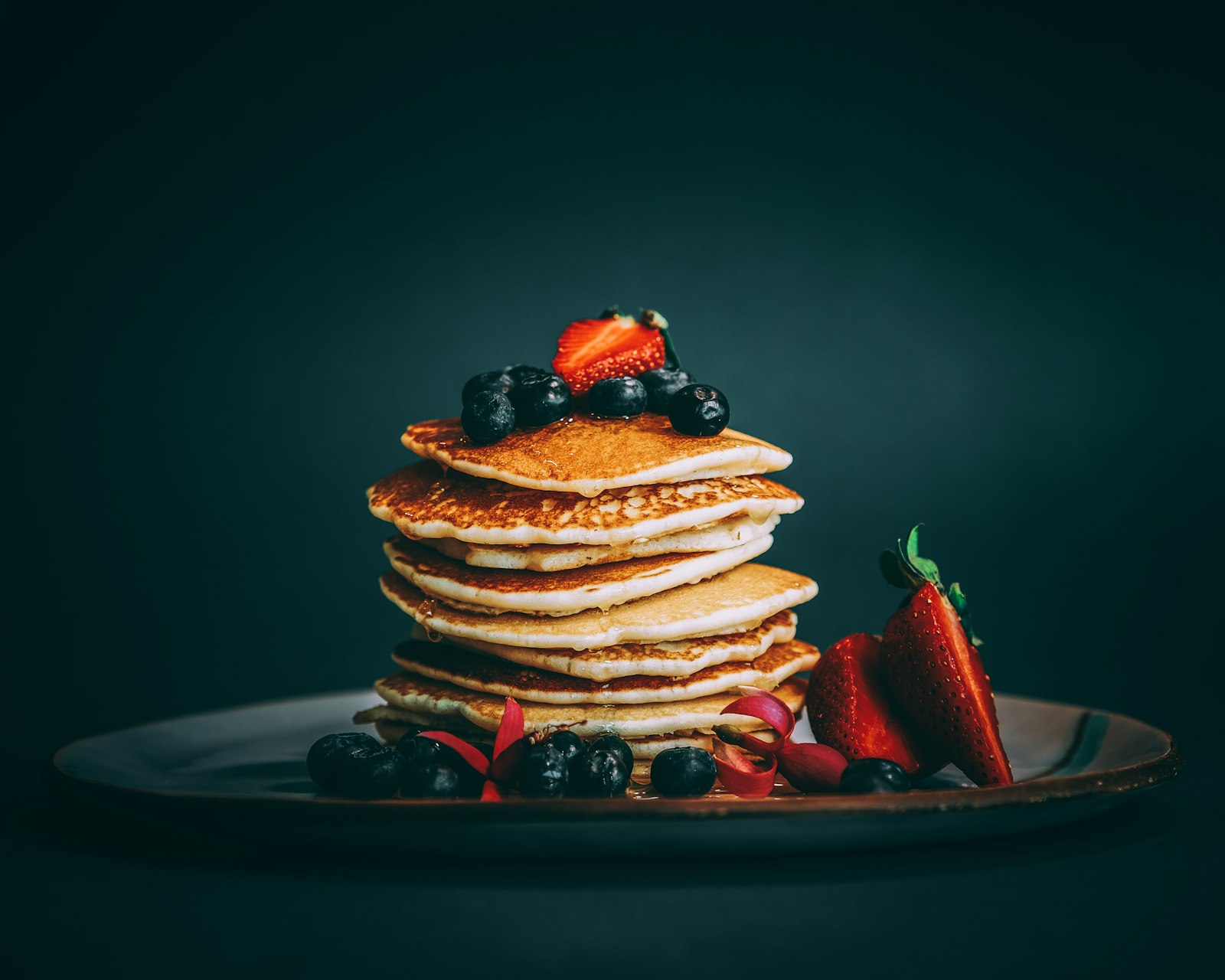 A tall golden stack with fresh berries