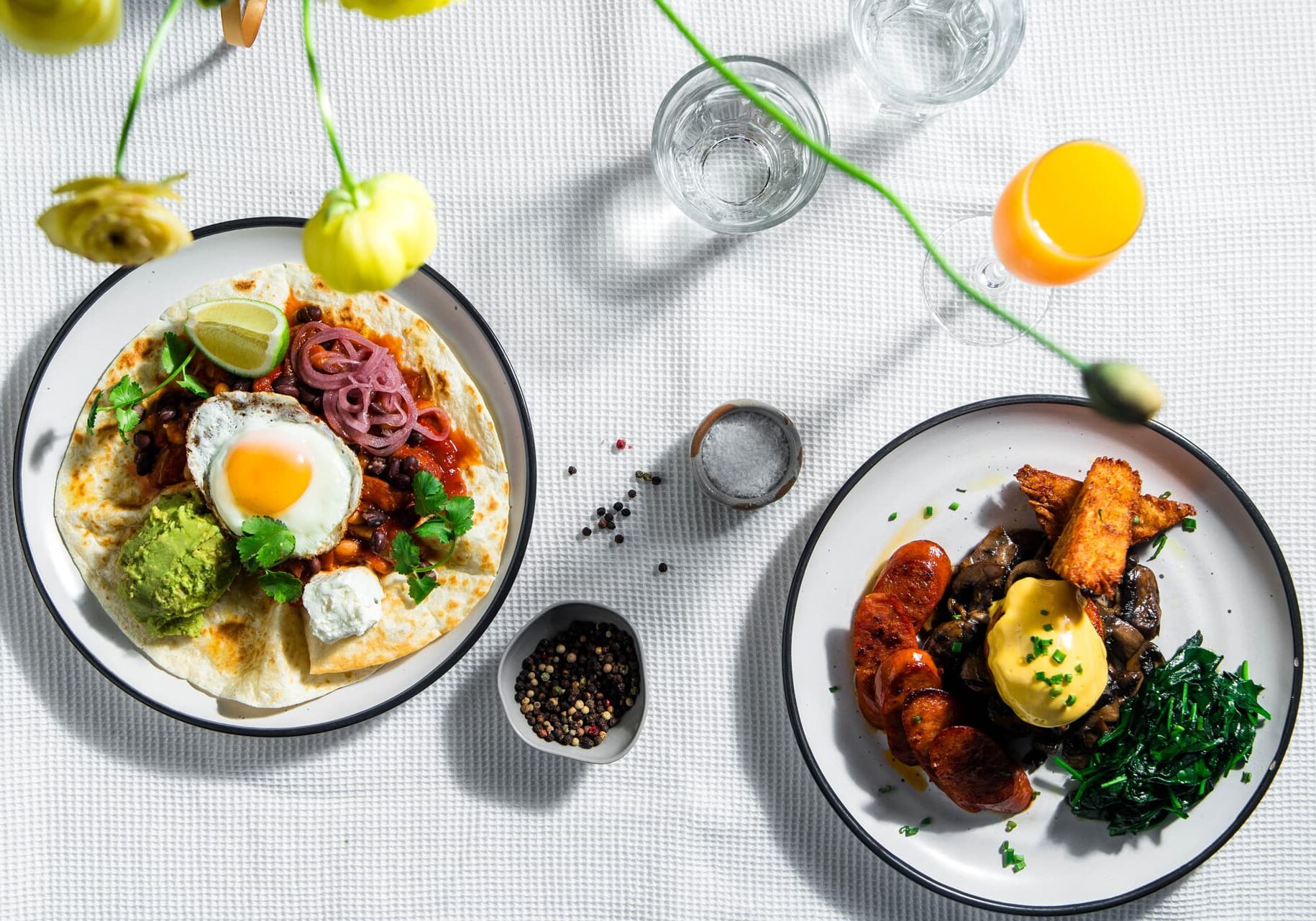 Overhead breakfast spread at The Turret — huevos-style eggs, chorizo, mushrooms and hollandaise